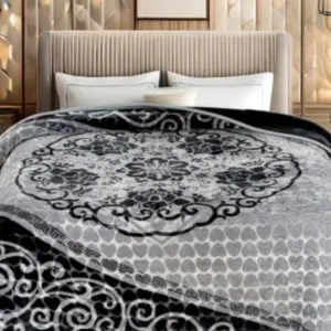 Stylish bedroom showing decorative black and grey floral blanket on bed