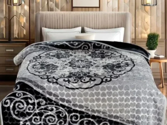 Stylish bedroom showing decorative black and grey floral blanket on bed